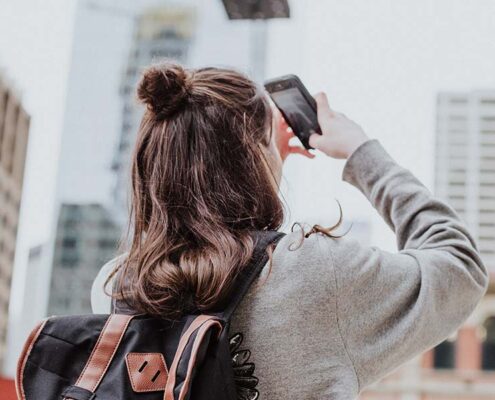 woman taking picture - sustainable tourist