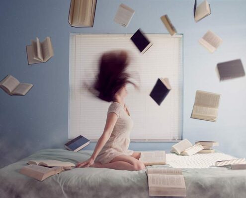 books and woman on bed - addicted to being busy