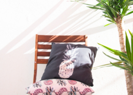 two throw pillows, a chair and a plant - designsoup by alix