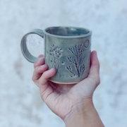 hand holding up a cup - meet the maker